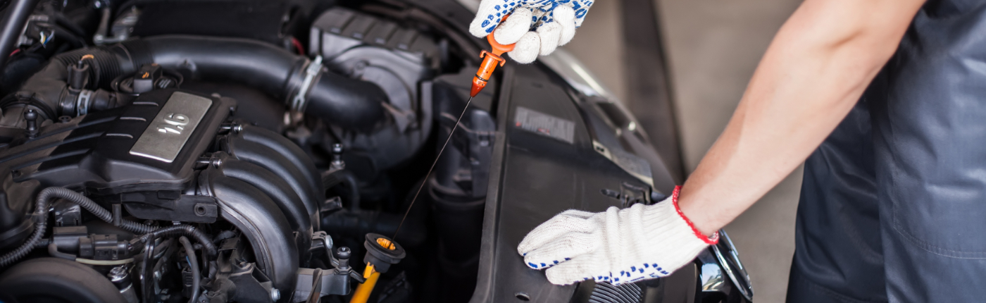 Mechanic doing a full oil check on a vehicle - Car Servicing Liverpool